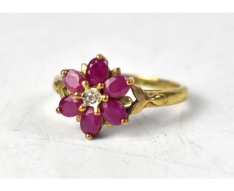 A 9ct yellow gold diamond and ruby flowerhead ring, with tiny illusion set central diamond within six ruby petals, size O, ap