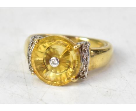A 9ct Lehrer Torus citrine and diamond ring, the central tiny bezel set diamond within a claw set bevel edged citrine disc, w