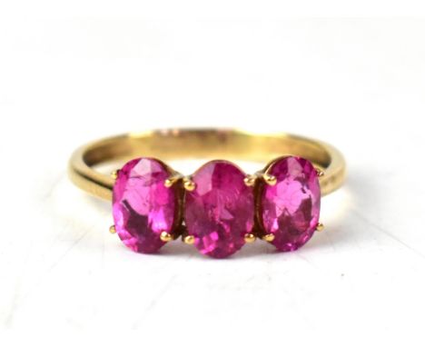 A 9ct gold three-stone Cruzeiro rubellite ring, on a 9ct yellow gold shank, size S, approx 2.4g. CONDITION REPORT Good condit