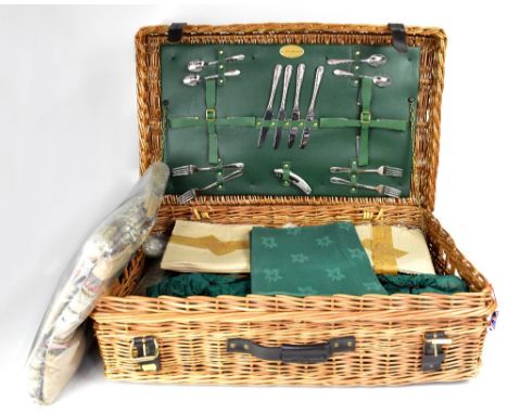 A Fortnum &amp; Mason wicker basket picnic set, in unused condition, with cutlery section to the underside of lid with corksc