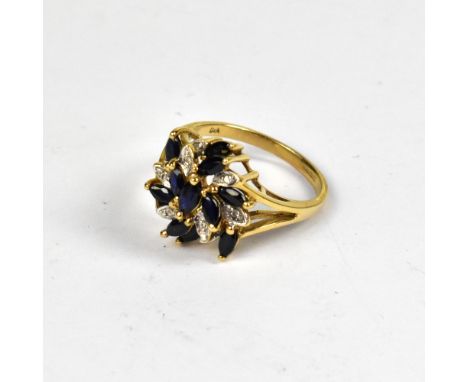 A modern 9ct gold diamond and sapphire cluster ring, the top comprising a naturalistic cluster of eight tiny illusion set dia