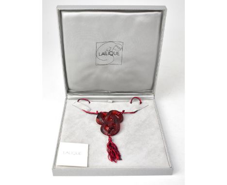 LALIQUE; a red glass pendant necklace in the form of an entwined snake, with textured body of scales, in burgundy-coloured gl