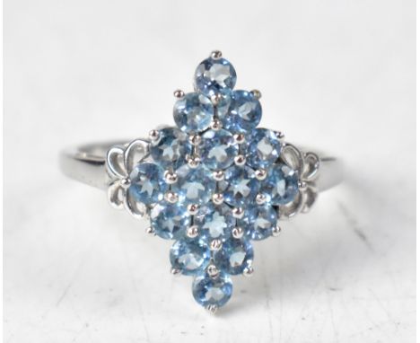 A 9ct white gold ring with a diamond-shaped cluster of sixteen London blue topaz round claw set stones, total approx 2.1ct, o