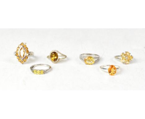 Six sterling silver citrine and Cognac quartz rings, comprising an oval claw set citrine solitaire ring, approx 2ct, size N, 