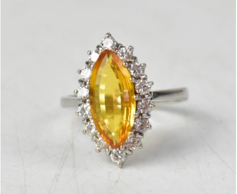 An 18ct white gold ring set with a marquise-shaped yellow tourmaline, with white diamond surround, size N1/2, approx 4.3g. CO