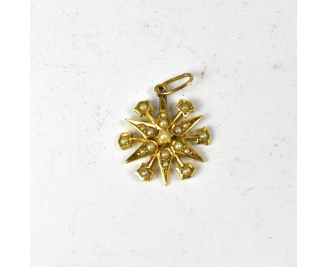 A vintage 15ct gold seed pearl encrusted star pendant, length 2cm, approx 2.1g.