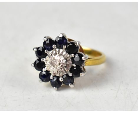 A 9ct yellow gold cluster ring set with a central diamond surrounded by sapphires, size M1/2, approx 4.1g.