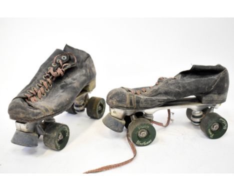 Two pairs of retro 1970s roller boots, gentlemen's 'Pacer Crown' in black with Pacer wheels and tartan laces, and ladies' whi