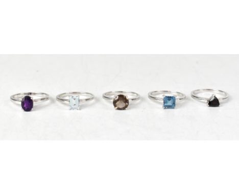 Five sterling silver rings, each with a different gemstone, comprising a round claw set smoky quartz, an oval claw set amethy