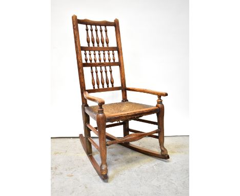 A 19th century rush seated bobbin back Lancashire-style provincial rocking chair.