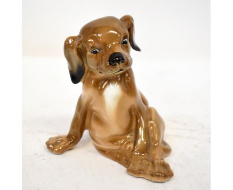 ROYAL DOULTON; an early 20th century porcelain figure of a seated puppy, HN128, with factory stamp to the underside, handwrit