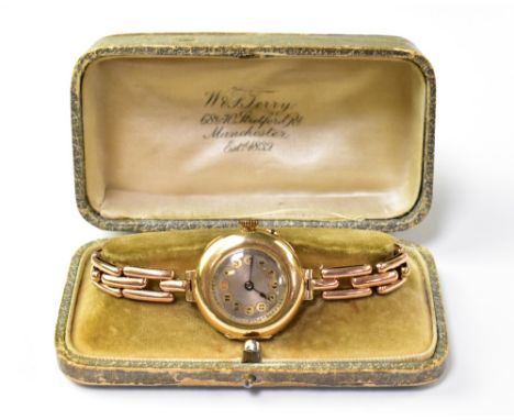 A cased ladies' vintage 9ct gold wristwatch, the engine turned silvered dial set with Arabic numerals within circle of discs,