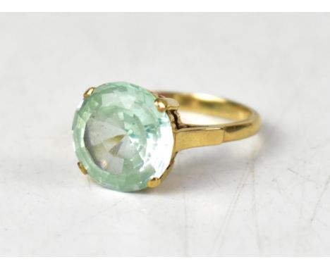 A 9ct yellow gold ring set with a circular pale blue stone, size N1/2, approx 3.6g.