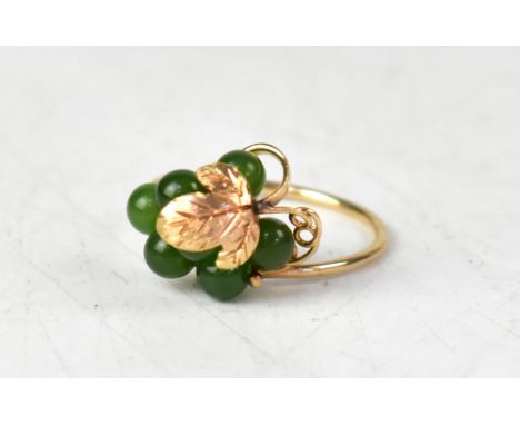 A 14ct yellow gold cluster ring in the form of a bunch of grapes, set with green jade spheres, with gold leaf and vine detail