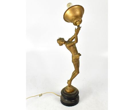 An Art Deco style gilded spelter table lamp in the form of a scantily-clad female, with globular shade, height 50cm (af).