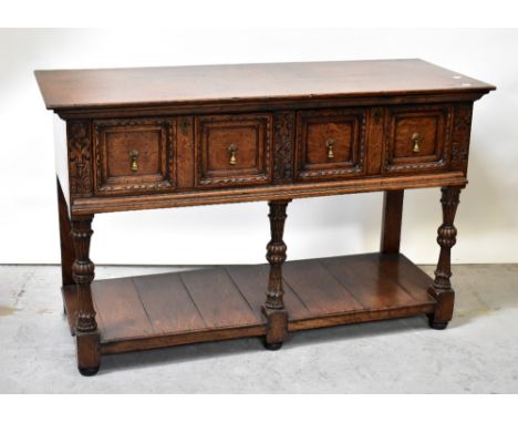 A 19th century oak side table, with a pair of carved panelled drawers interspersed with carved acanthus leaf panels, raised o