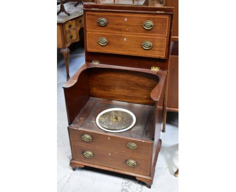 A 19th century mahogany line inlaid commode in the form of a four-drawer bachelor's chest, the hinged upper section opening t