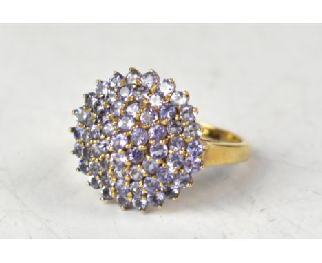 A 9ct yellow gold tanzanite domed cluster ring, size O, approx 4g. CONDITION REPORT Good condition, no missing stones, no sig