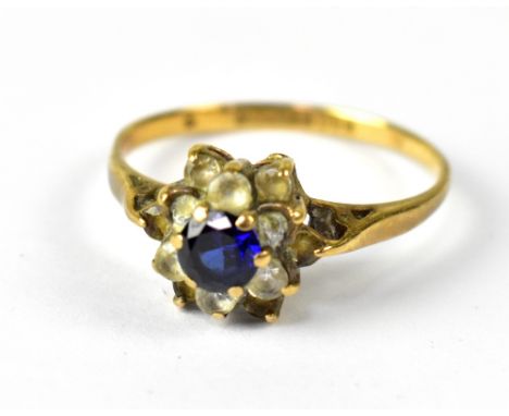 A 9ct yellow gold ladies' dress ring, floral set with central blue sapphire and white stone surround, size P, approx 1.8g.