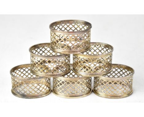 A set of six Elizabeth II hallmarked silver napkin rings of oval form, each with pierced trellis-style decoration and engine 