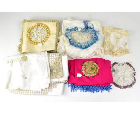 A quantity of vintage textiles and linen to include crochet doilies, beaded doilies, netting, silk cutwork tablecloth, furthe
