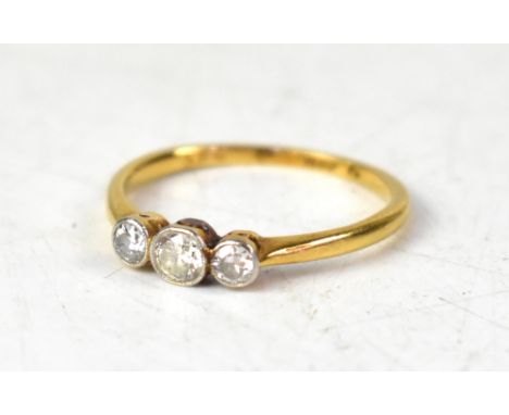 An 18ct yellow gold three-stone diamond ring, the three brilliant cut diamonds set in a white gold mount, size O, approx 2.1g