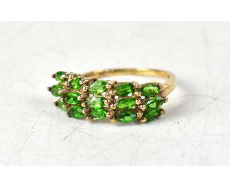 A 9ct yellow gold ring with three rows of five claw set chrome diopside, size O, approx 2.4g. CONDITION REPORT There seems to