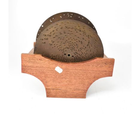 A collection of sixteen polyphon discs on associated wooden stand (17).