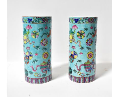 A pair of 20th century Chinese brush pots, both of cylindrical form and decorated with koi carp, lanterns, balls, ribbons and