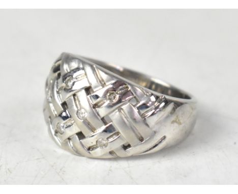 A 9ct white gold ring with a woven design set with eight tiny diamond chips, total approx 0.16ct, size O, approx 7.4g.