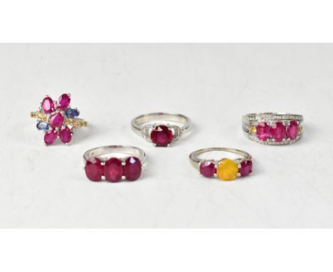 Five hallmarked sterling silver rings, comprising a ruby, sapphire and diamond ring, three claw set oval rubies, total approx