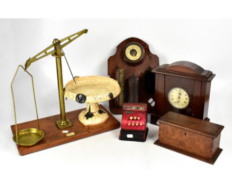 A group of collectors' items, including brass balance scales, clock, carved box, etc.