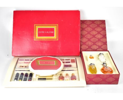 A boxed Ralph Laurent Safari set of perfume to include a large ovoid bottle with silver top and matching purse-sized perfume 