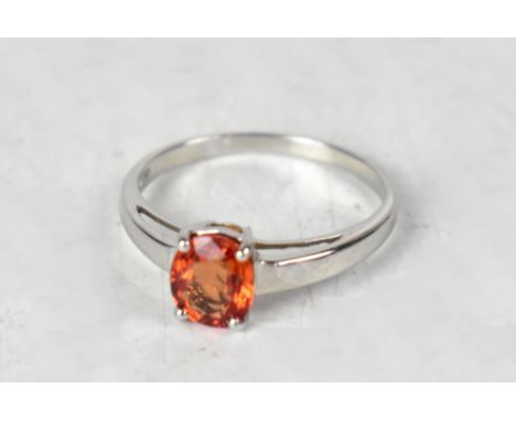 A 9ct white gold orange sapphire solitaire ring, size O, approx 1.8g.