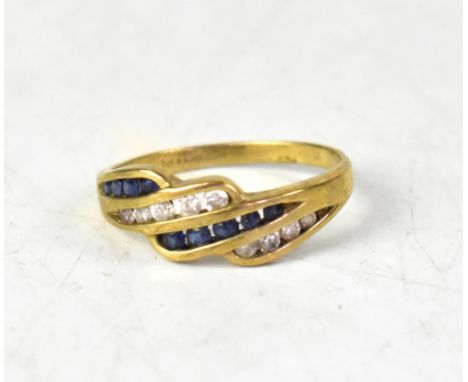 A modern 9ct gold sapphire and white stone crossover ring, with three crossover lines of blue sapphires and white stones, on 