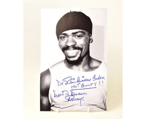 RUBIN 'HURRICANE' CARTER; a black and white photograph bearing the boxer's signature, inscribed 'Not guilty!! Dare to dream a