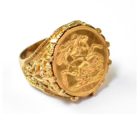 A George V 1912 full sovereign mounted in a 9ct gold ring with floral pierced shoulders, size X, approx 15.7g.