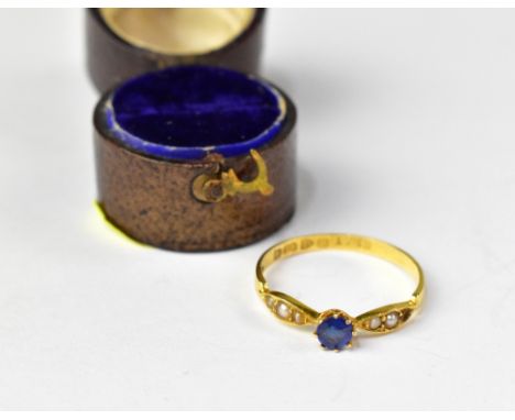 An Edwardian 18ct gold ring with prong set blue sapphire flanked by two oval shoulders with three graduated pearls, size P, C