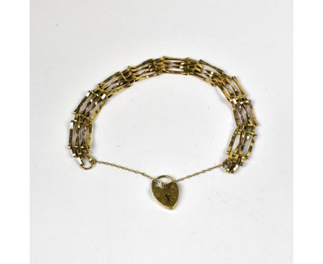 A vintage 9ct gold four bar gate bracelet united with a 9ct gold heart-shaped padlock clasp and safety chain, length approx 1