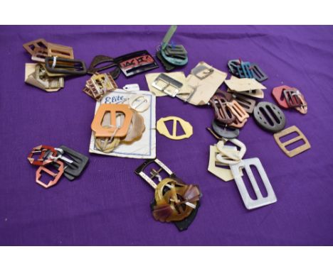 A bag full of vintage and antique buckles, many bright bakelite and early plastic examples.