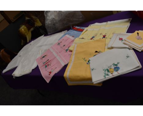 An assortment of vintage and antique linen including novelty Chinese table cloth sets and embroidered pillow slips etc.