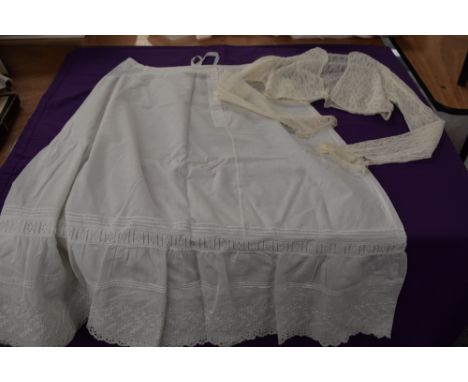 An antique petticoat having cutwork and pin tuck detailing sold with a fine tulle lace jacket.