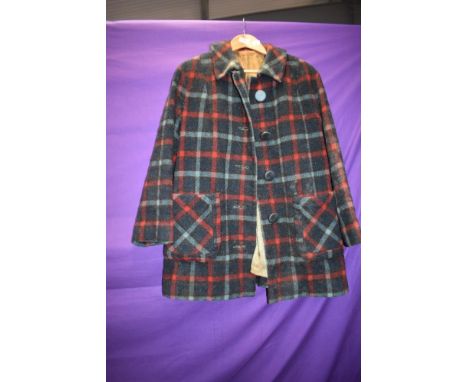 A 1950s tartan jacket having two pockets and large buttons to front, some wear to lining and would benefit from a bath as is 