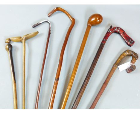 A BAMBOO WALKING STICK, THE HANDLE VARIOUSLY CARVED WITH MONKEY FIGURES AND RETAINING REMNANTS OF ORIGINAL PAINT, A FOLK ART 