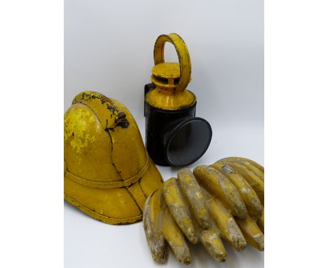 A VINTAGE SHOP DISPLAY BUNCH OF BANANAS, A FIREMAN'S HELMET AND A VINTAGE RAILWAY SIGNALMAN'S LAMP.