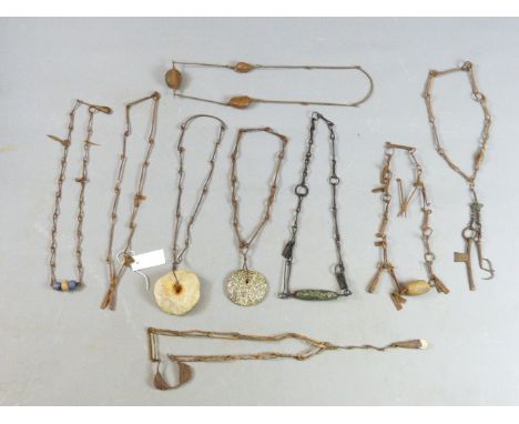TWENTY TWO VARIOUS AFRICAN IRON AND STONE SET NECKLACES, SOME HUNG WITH IRON CURRENCY GONGS, SCISSORS AND TOOLS. DOGON PEOPLE