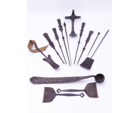 AN INTERESTING MIDDLE EASTERN IRON LADLE, A GROUP OF IRON AND BRASS INSET LONG HAIR? OR CLOAK PINS? AN AFRICAN IRON PENDANT/ 