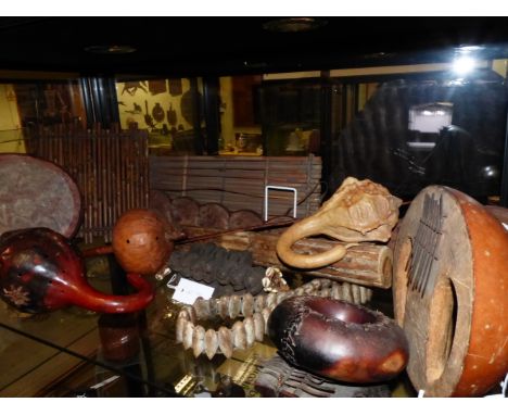 TWO WEST AFRICAN MBIRA (THUMB HARP) MUSICAL INSTRUMENTS TOGETHER WITH A GROUP OF GOURD MARACAS AND OTHER BEAN POD INSTRUMENTS