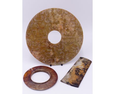 AN ARCHAISTIC CHINESE JADE BI DISC WITH CARVED DECORATION IN SHALLOW RELIEF TO BOTH SIDES 21 CM DIA. ANOTHER  BI DISC WITH RA