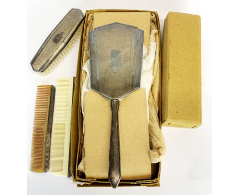 An Art Deco hallmarked silver hand mirror comb and brush with original boxes.